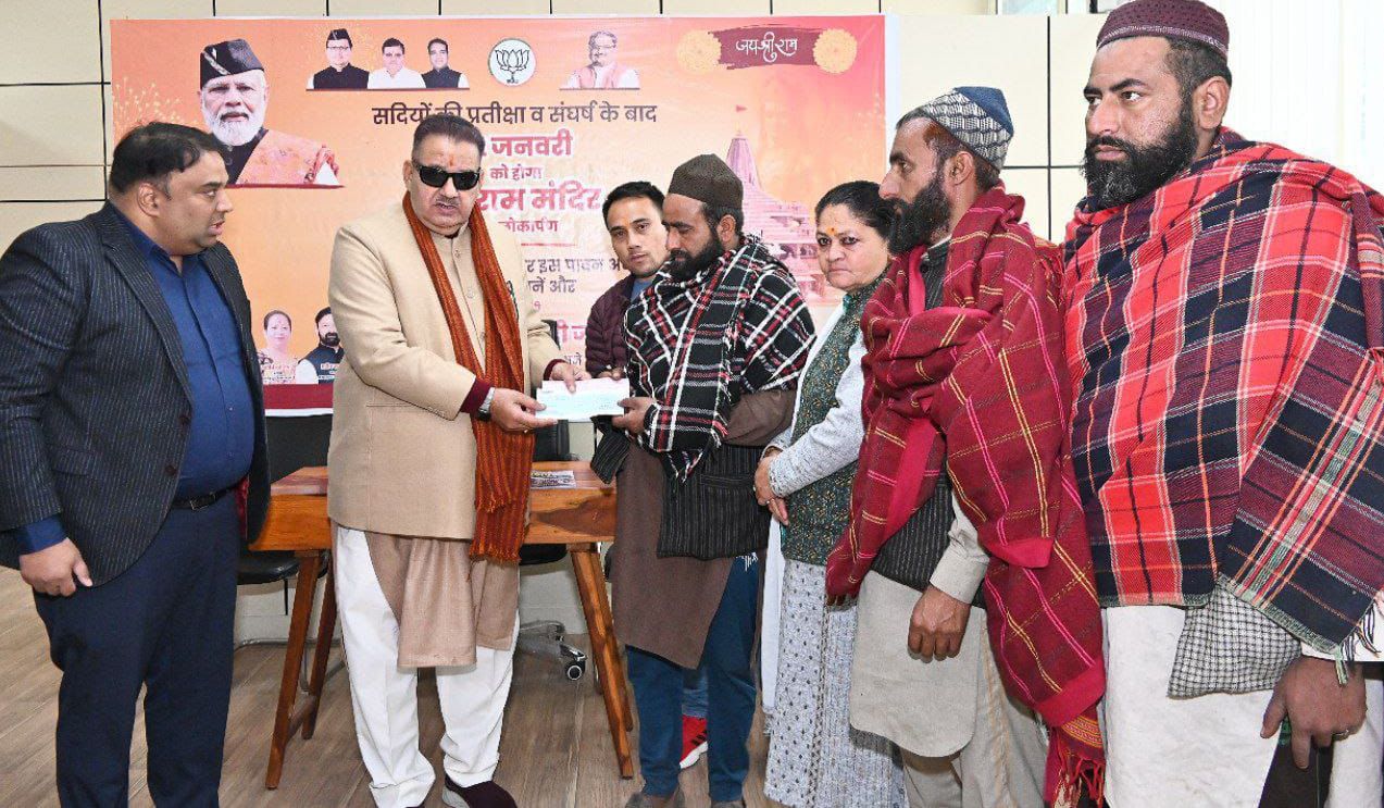 Cabinet Minister Ganesh Joshi giving a check of compensation amount to the families of the victims of Guldar attack.